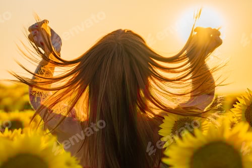 Preview: Woman in Sunflower Field During Sunset