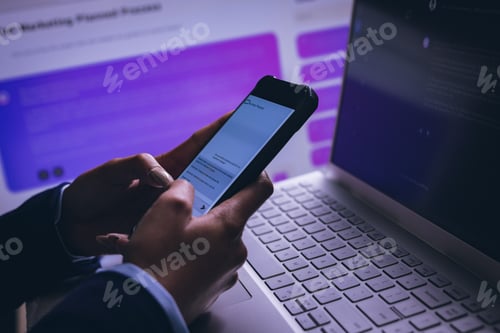 Preview: Biracial businesswoman using smartphone and laptop on black background