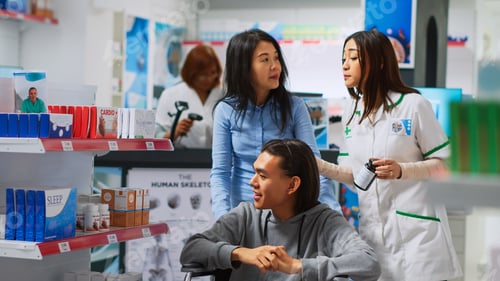 Preview: Young man in wheelchair coming to pharmacy to buy drugs