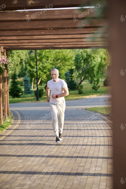 Preview: A man in sporstwear jogging in the park