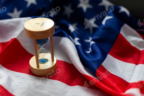 Preview: Hourglass and USA flag, soft focus, copy space