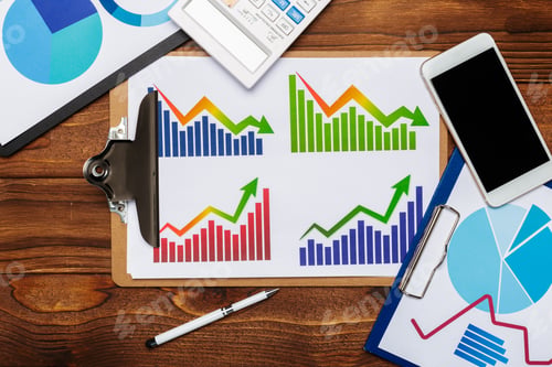 Preview: Trend analysis on clipboard with graphs, smartphone, and calculator at office desk workspace