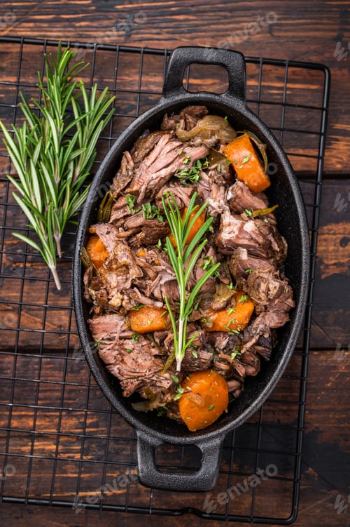 Preview: Skillet of beef bourguignon with tender beef, carrots, and mushrooms. wooden background. top view