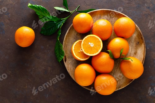 Preview: Oranges with leaves on dark background, top view