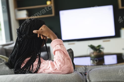 Preview: African american woman watching tv with copy space, slow motion