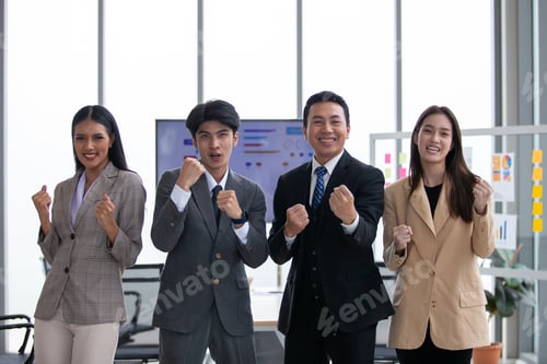 Preview: Asian business team celebrate corporate victory together in office.