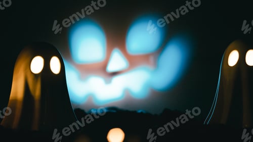 Preview: Twin ghost figurines with jack-o'-lantern face projected