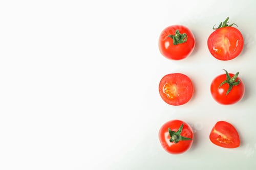 Preview: Flat lay composition with fresh cherry tomatoes on white background, space for text. Ripe vegetables