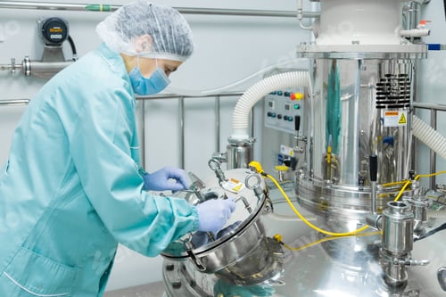 Preview: Pharmaceutical factory woman worker in protective clothing operating production line in sterile