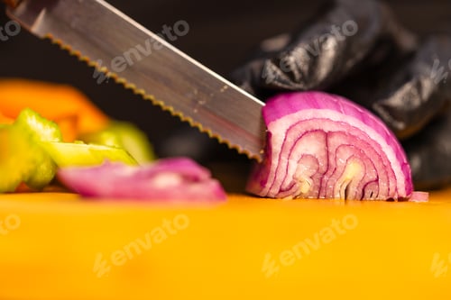 Preview: Chef slicing red onion for fresh salad preparation