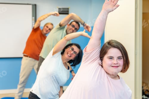 Preview: Group of people with special needs stretching in the gym