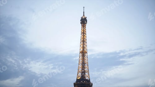 Preview: Tourists at shining Eiffel tower in evening. Action. Many tourists sit on lawn and enjoy beautiful