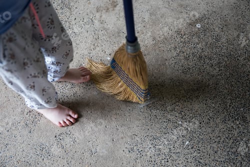 Preview: Looking down at young girl feet helping family sweeping