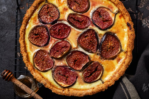 Preview: Homemade quiche tart with figs, cream cheese and honey on dark brown background. Vintage style. Top