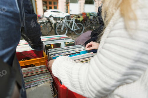 Preview: Cropped image of woman choosing books arranged in crate at flea market