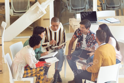 Preview: Side view of diverse Business people sitting together and having group discussion in office