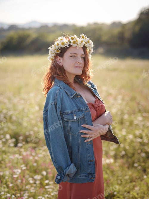 Preview: red-haired woman on field on summer evening