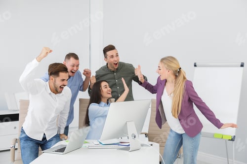 Preview: Group of office employees celebrating victory at workplace