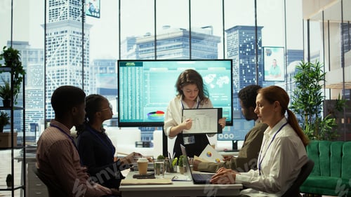Preview: Business associates reviewing key performance indicators within the enterprise