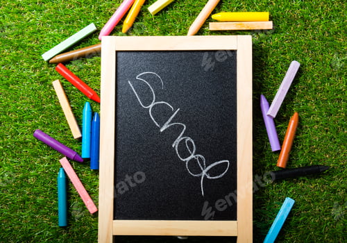 Preview: top view, school accessories on green grass. Back to school concept