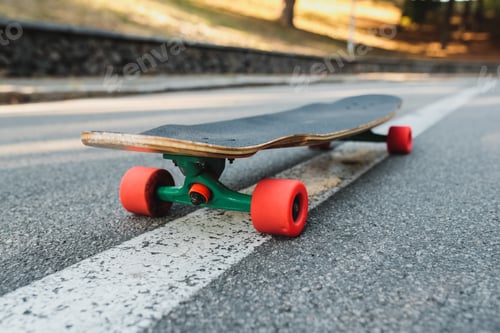 Preview: Longboard with red wheels on the asphalt.