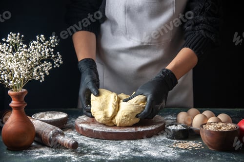 Preview: front view female cook rolling out dough on dark background pastry job raw dough hotcake bakery pie