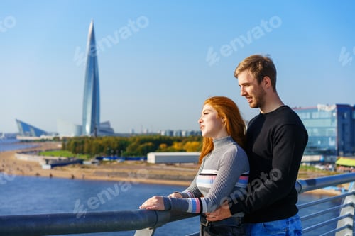 Preview: A guy and a girl are standing on the river bridge