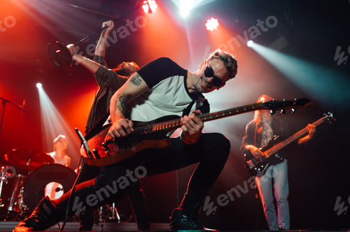 Preview: Guitarist performing live on stage with bandmates