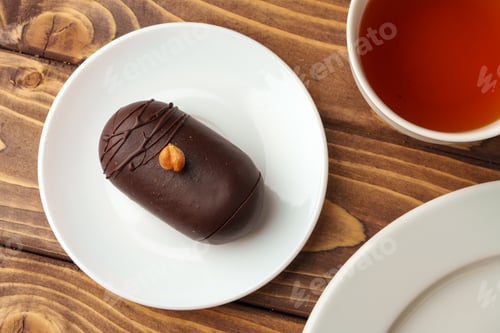 Preview: Delicious chocolate cake in white plate on wooden table background
