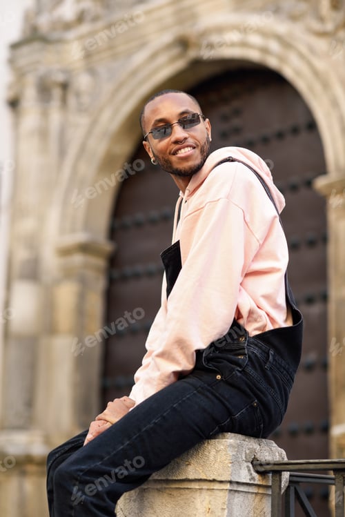 Preview: Young black man wearing casual clothes and sunglasses outdoors
