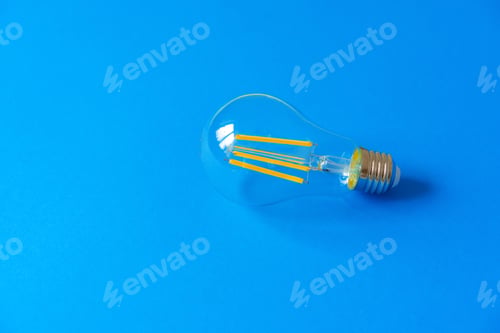 Preview: One light bulb on a blue paper background