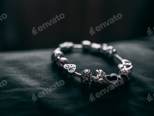 Preview: Closeup shot of a metal bracelet on a black surface
