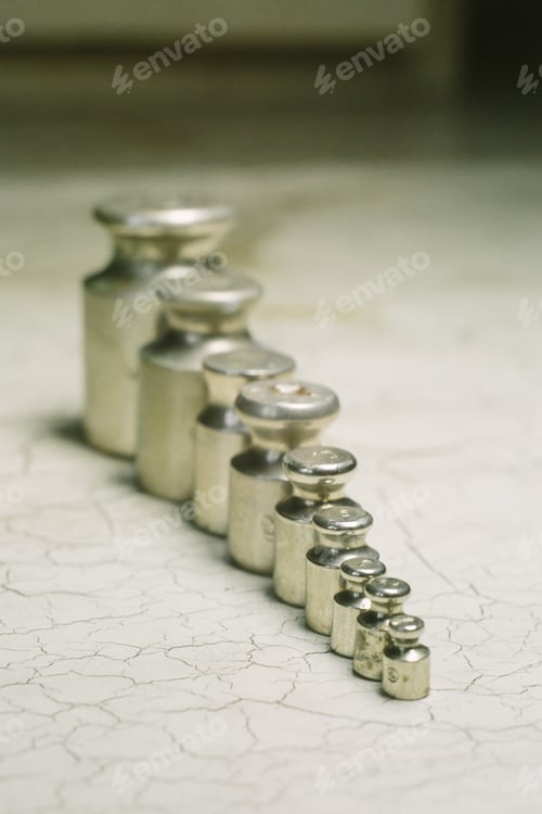 Preview: Set of pharmacy laboratory precision weights for a balance scale on an old table. Pharmacy set of