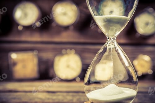 Preview: Aged hourglass with flowing sand