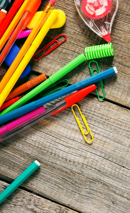Preview: School tools. On wooden background.