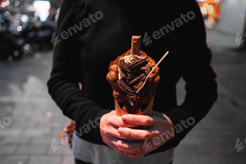 Preview: chocolate chip cookie ice cream held in hands