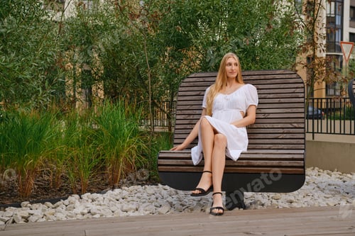 Preview: Young woman sitting on a rotating bench