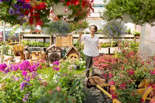 Preview: Contemporary florist or gardener walking through garden center