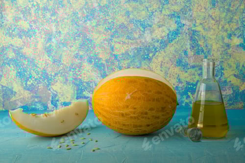 Preview: Melon fruit and seeds with a glass jar of juice on blue background