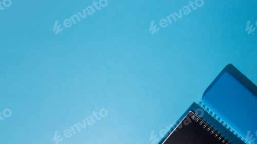 Preview: Top view of a smartphone and a notepad on a blue background