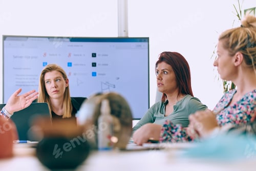 Preview: Diverse Business Team Discussing Projects in a Modern Glass Office.