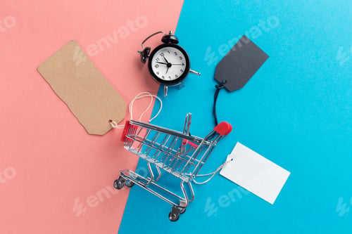 Preview: Small shopping cart with alarm clock. Shopping time concept