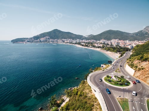 Preview: Highway with a circular turn over the sea at the foot of the mountains. Budva, Montenegro. Drone