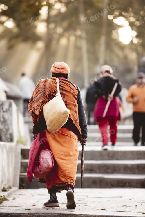 Preview: Vertical shot of an elderly person wearing Hindu robes with a blurred background