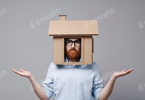 Preview: Desperate homeowner with cardboard house on his head