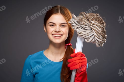 Preview: emotional woman with a mop in hand cleaning rooms home care