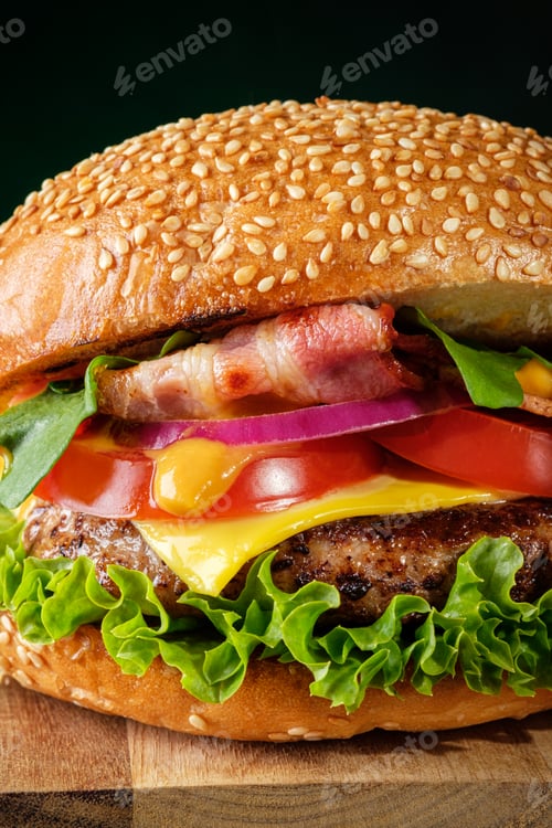 Preview: Closeup view of fresh tasty burger on dark background. Fast food concept. Junk food.