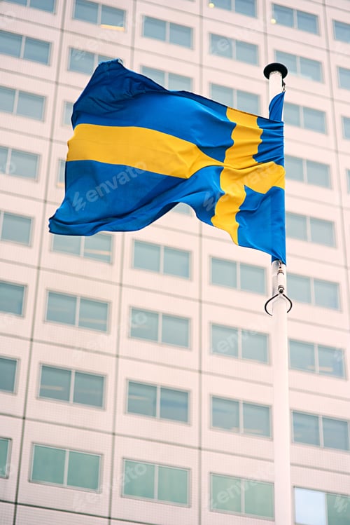Preview: Swedish Flag Waving with Modern Building Backdrop