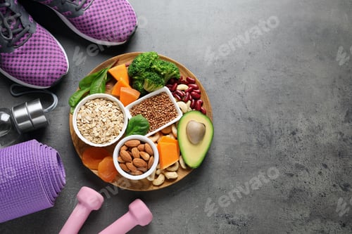 Preview: Plate with heart-healthy products and sports equipment on grey background, flat lay. Space for text