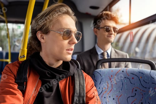 Preview: selective focus of pensive man looking away in public transport